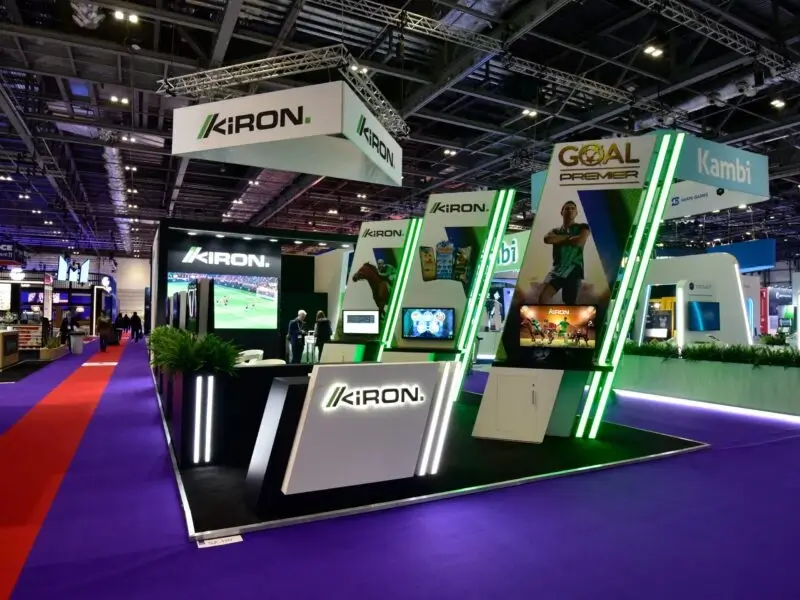 An exhibition booth featuring sports-themed displays, interactive screens, and technology at a trade show in 2025, crafted by PKO, a leading exhibition company in UAE.