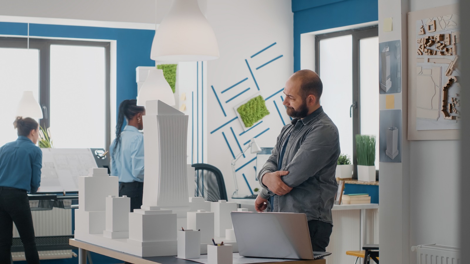 Creative team of Exhibition Stand Designers in Dubai working on custom trade show booth design model